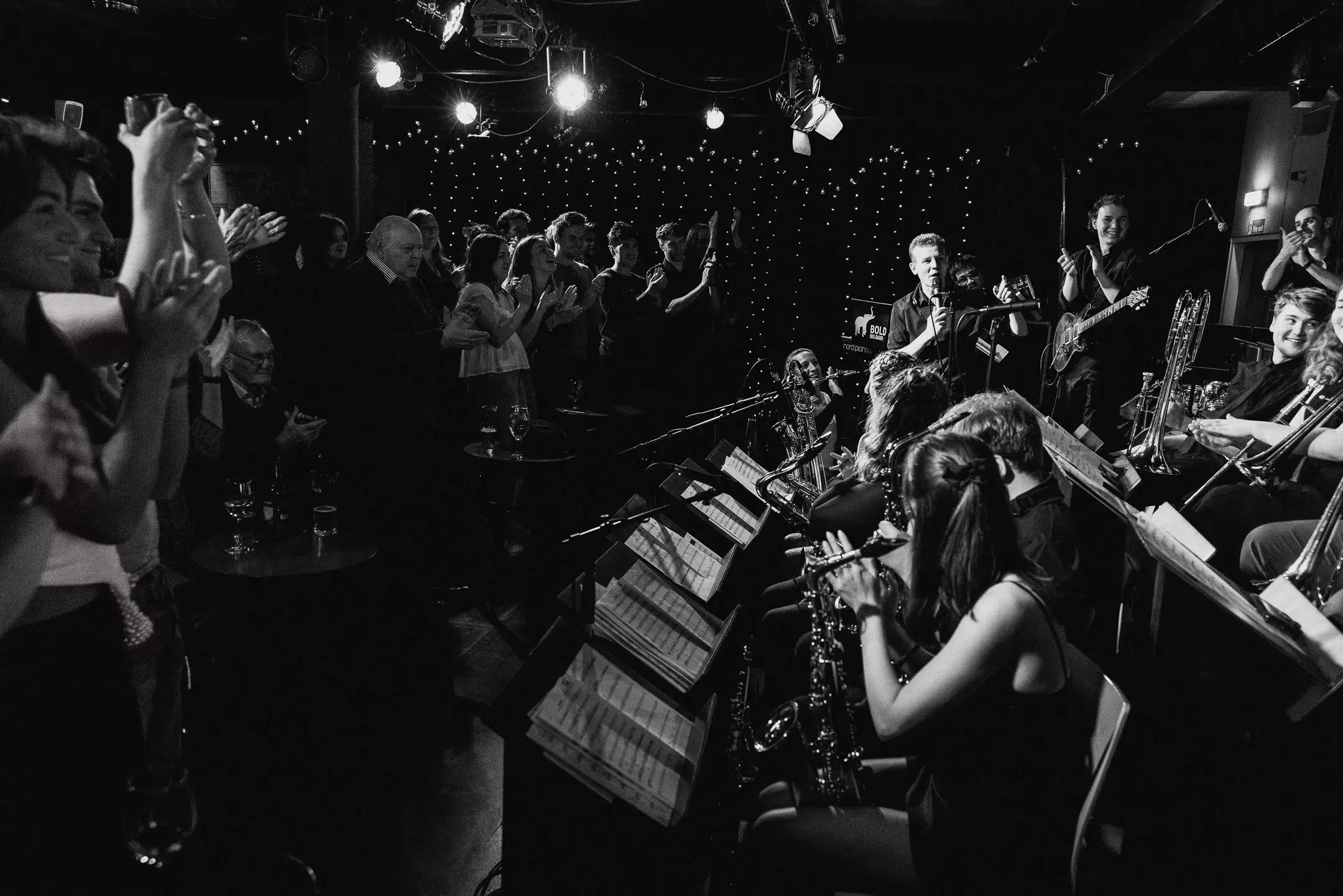 Black and white picture of standing ovation towards the band
